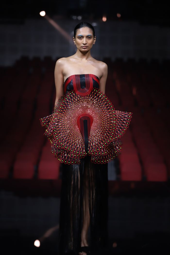 Stylish model showcasing avant-garde fashion on a runway in New Delhi.