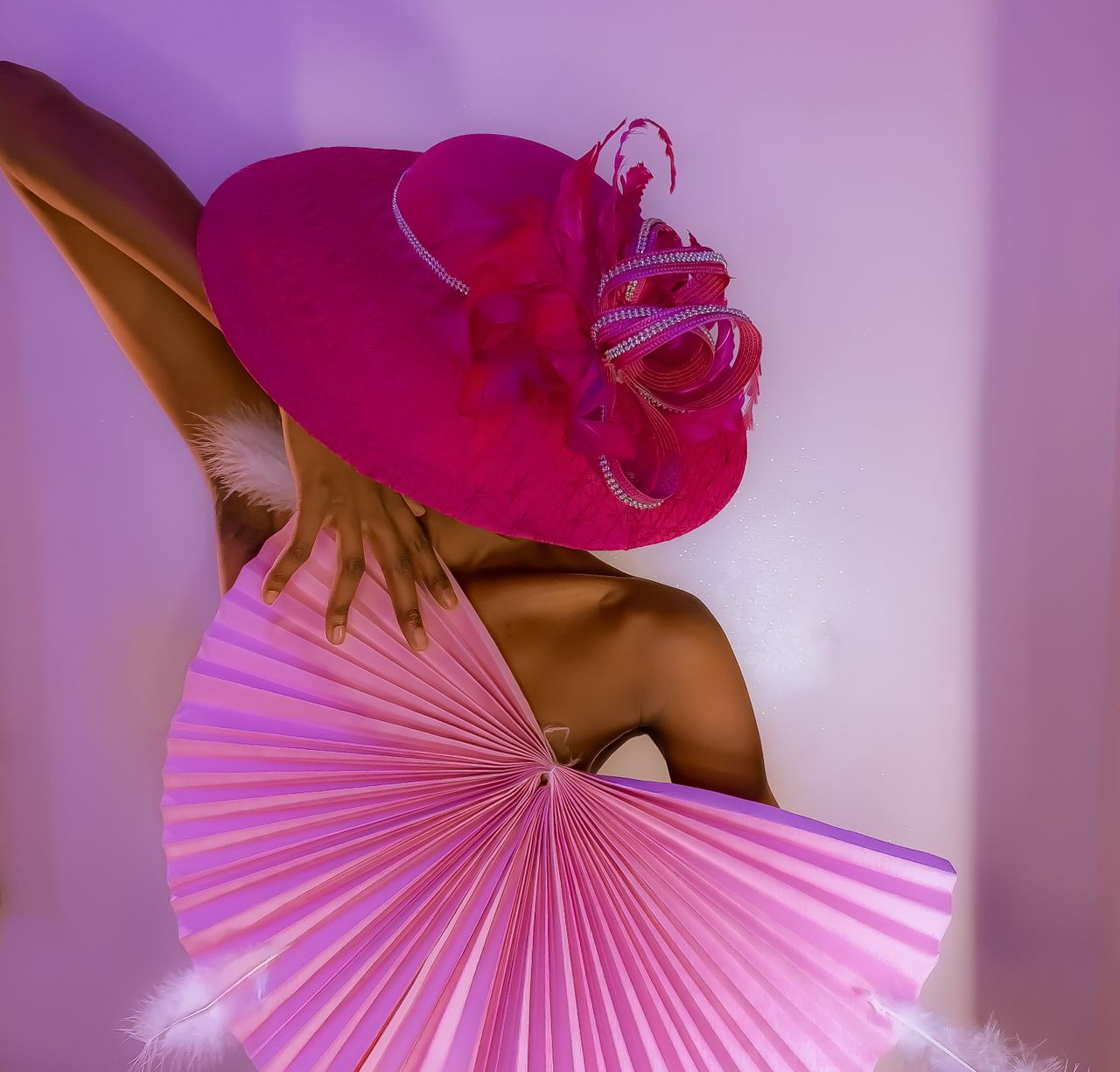 Crafting Captivating Headlines: Your awesome post title goes here A fashionable woman posing with a vibrant red hat and fan, showcasing elegance and style in a studio setting.