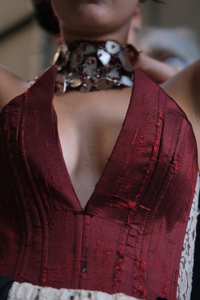 Close-up of a stylish burgundy dress with intricate collar detail showcasing fashion elegance.